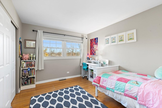 bedroom with wood-type flooring and a closet