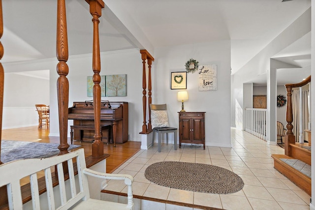 entryway with crown molding and light tile patterned floors