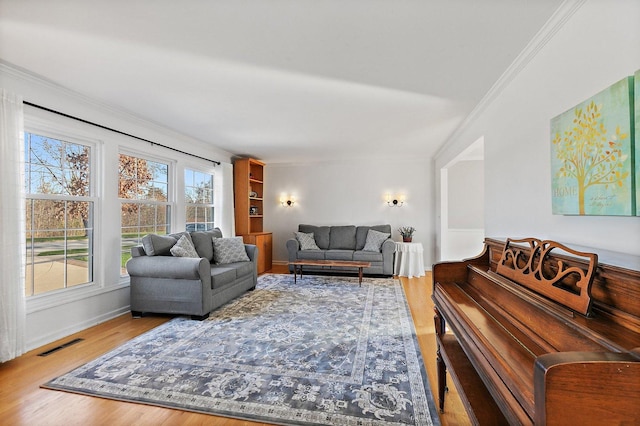 living room featuring hardwood / wood-style floors and ornamental molding