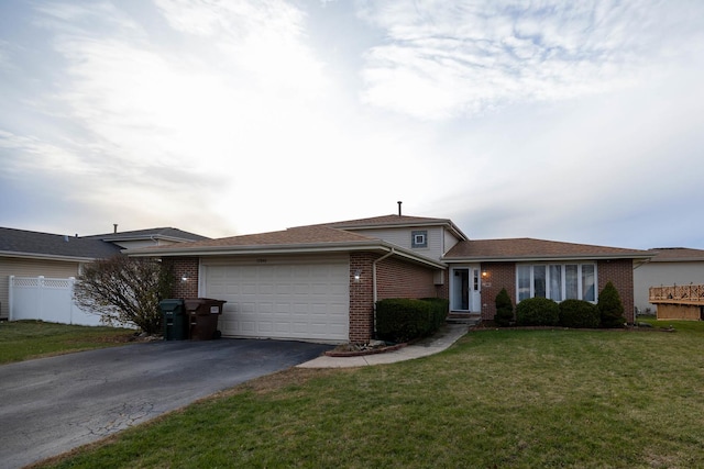 view of front of property with a front yard and a garage