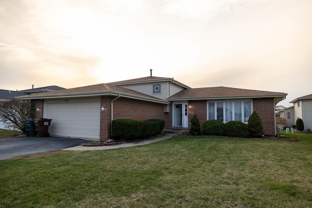 view of front of property featuring a lawn and a garage