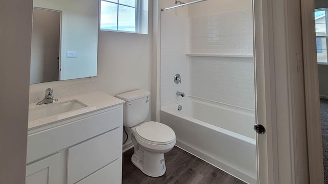 full bathroom with bathtub / shower combination, wood-type flooring, vanity, and toilet