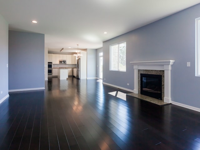 20137 Preston Ln, Lynwood, IL 60411 - unfurnished living room featuring a high end fireplace, recessed lighting, a chandelier, and dark wood finished floors