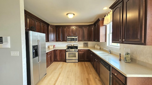 20137 Preston Ln, Lynwood, IL 60411 - kitchen featuring appliances with stainless steel finishes, light wood-style floors, dark brown cabinetry, and light countertops