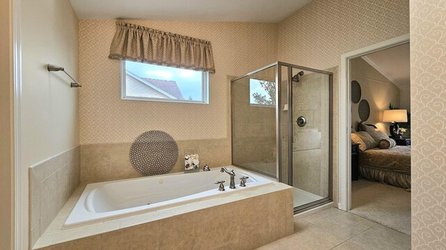 bathroom featuring tile patterned flooring and independent shower and bath