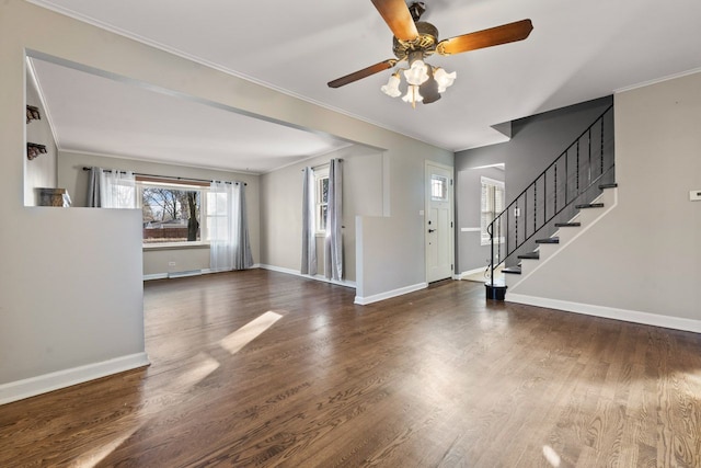 entryway with stairs, crown molding, wood finished floors, and baseboards