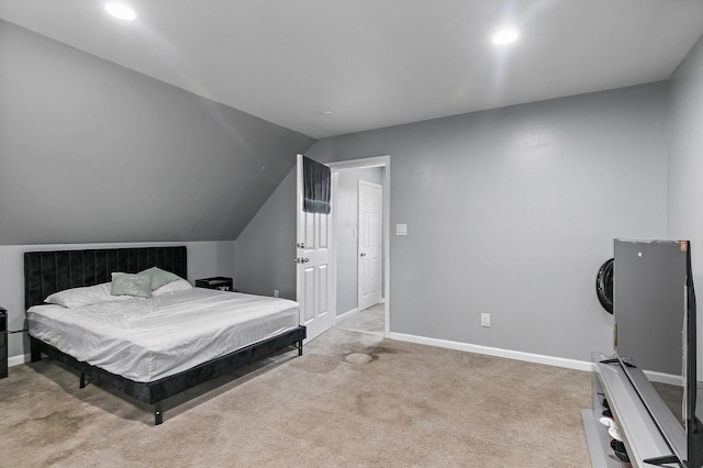 carpeted bedroom with lofted ceiling