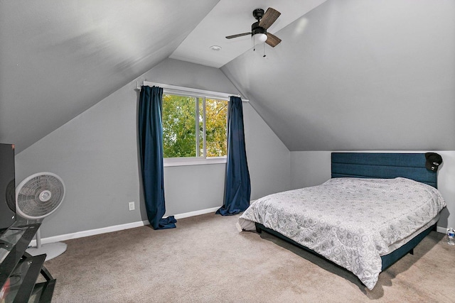 carpeted bedroom with ceiling fan and vaulted ceiling