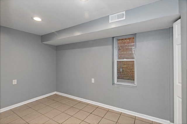 basement featuring light tile patterned floors