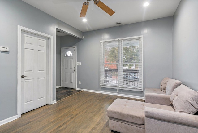 sitting room with dark hardwood / wood-style floors and ceiling fan