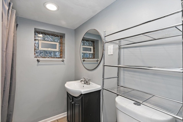 bathroom featuring vanity and toilet