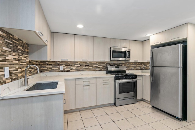 kitchen featuring decorative backsplash, light tile patterned flooring, sink, and appliances with stainless steel finishes