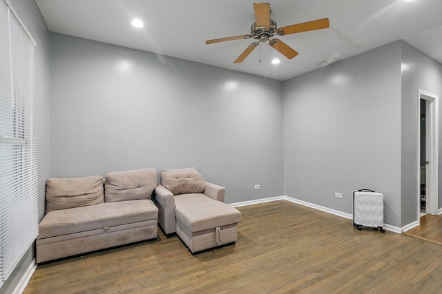 living area featuring hardwood / wood-style flooring and ceiling fan