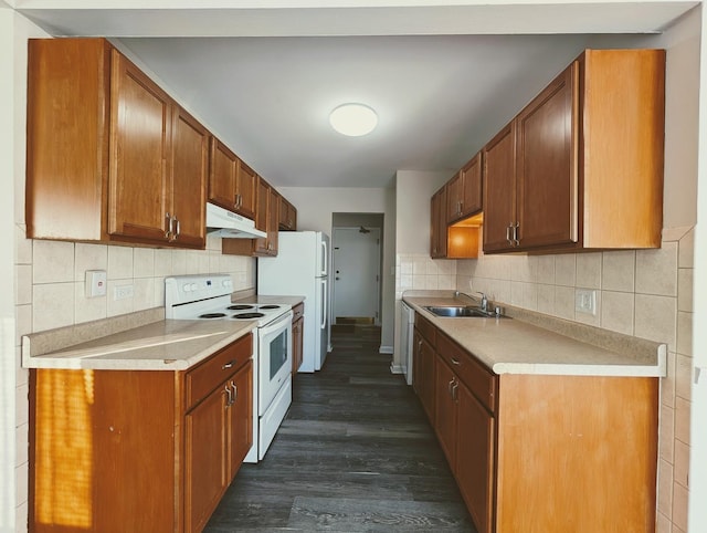 kitchen featuring sink, white appliances, backsplash, and dark hardwood / wood-style flooring