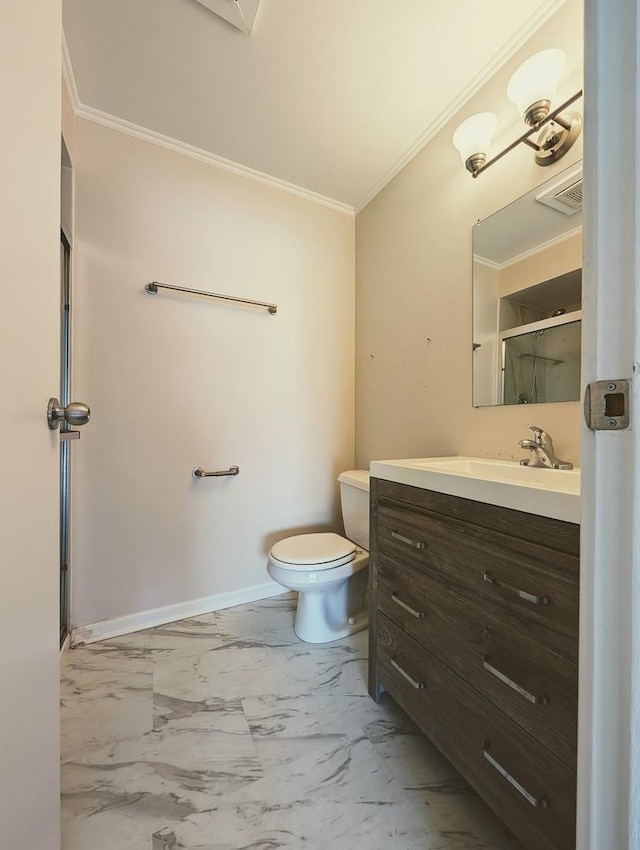 bathroom with toilet, ornamental molding, and vanity