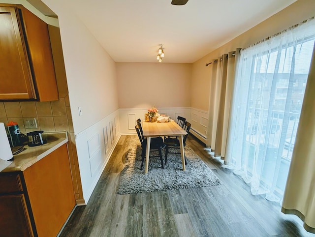 dining area with a baseboard heating unit and dark hardwood / wood-style floors