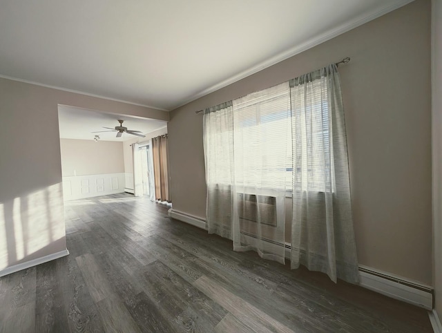 unfurnished room with ceiling fan, baseboard heating, and dark hardwood / wood-style floors