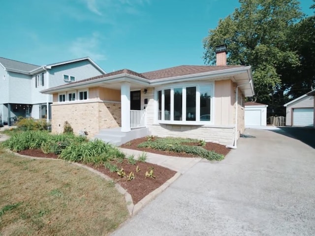 view of front facade featuring a garage and an outbuilding