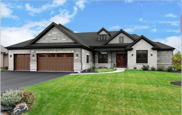 view of front of house with a garage and a front lawn