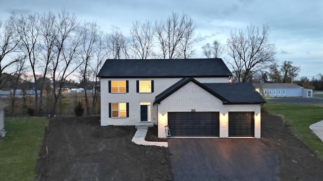 view of front of property with a lawn and a garage