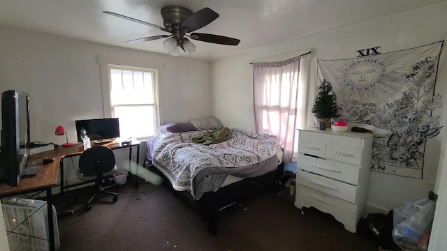 bedroom with dark colored carpet and ceiling fan