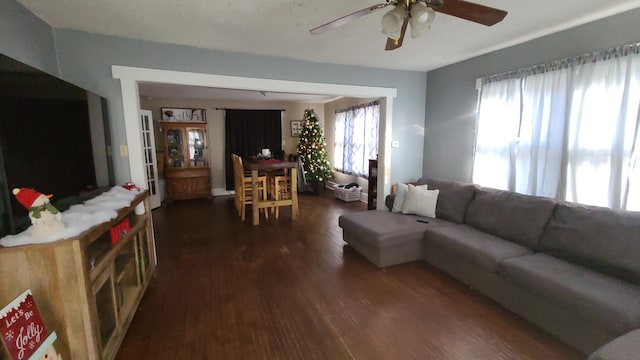 living room with dark hardwood / wood-style floors and ceiling fan