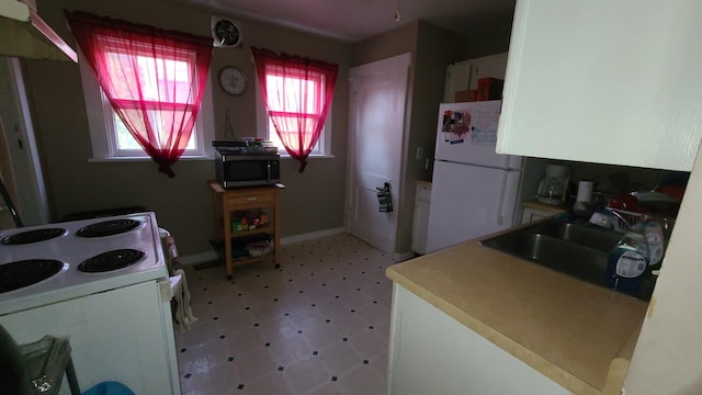 kitchen with sink and white appliances