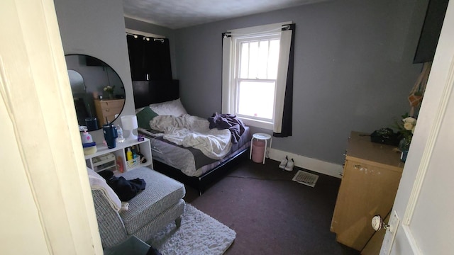 bedroom with dark colored carpet