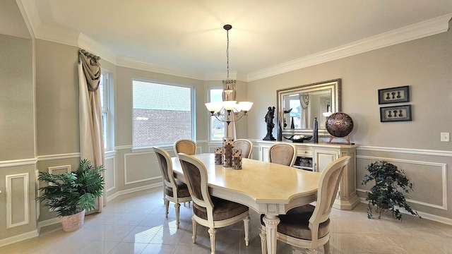 tiled dining space featuring a chandelier and crown molding