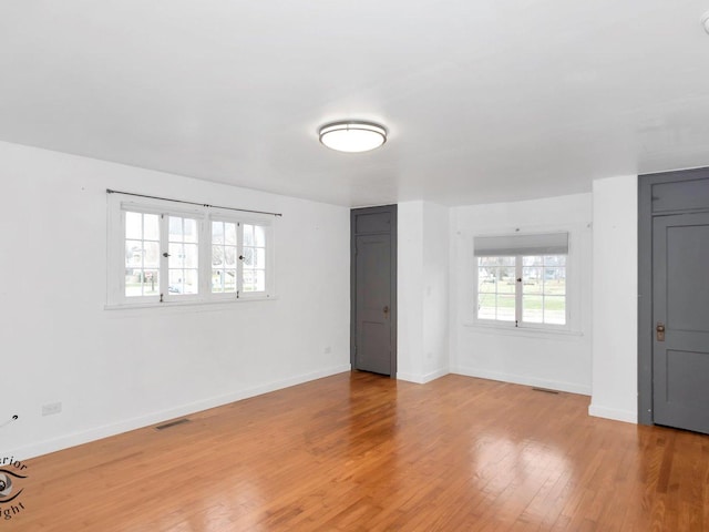 unfurnished room with light wood-type flooring