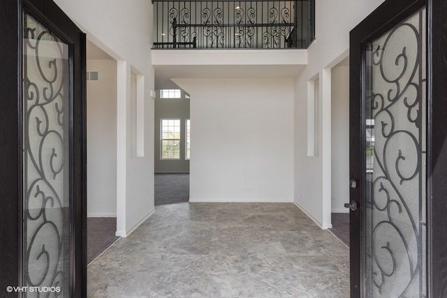 foyer featuring a towering ceiling