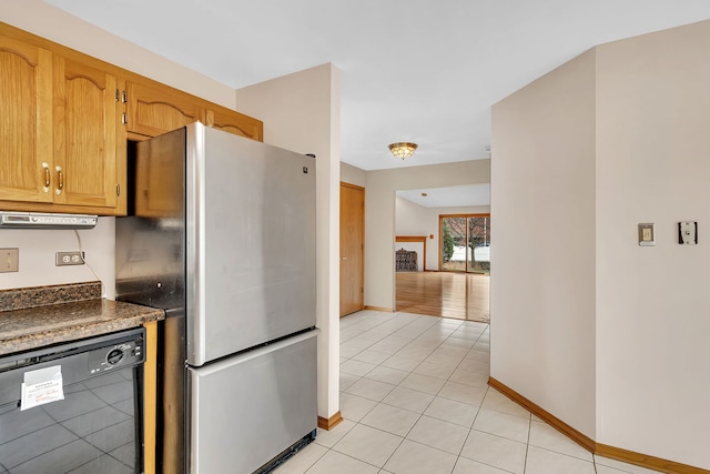 kitchen featuring dishwasher, stainless steel fridge, and light tile patterned floors