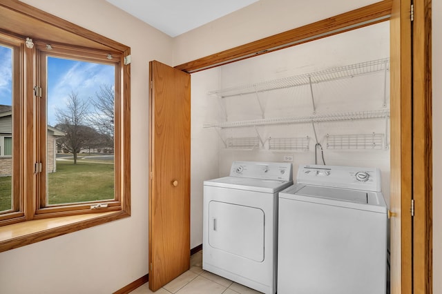 laundry room with washer and dryer, light tile patterned floors, and a healthy amount of sunlight