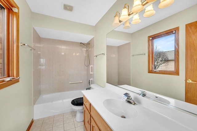 full bathroom with tile patterned flooring, vanity, toilet, and tiled shower / bath