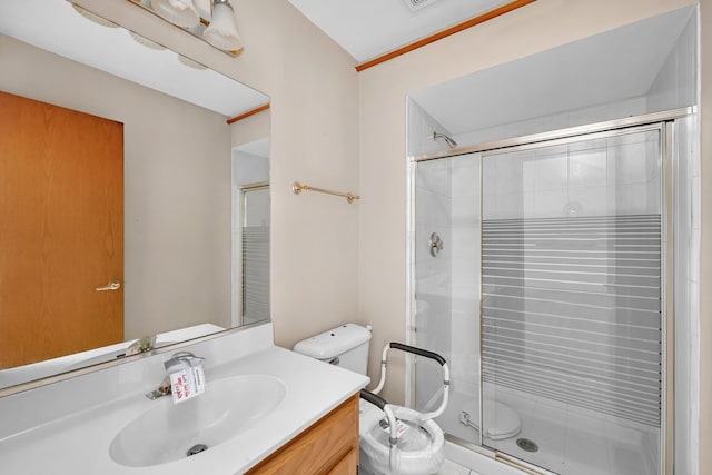 bathroom with vanity, toilet, and an enclosed shower