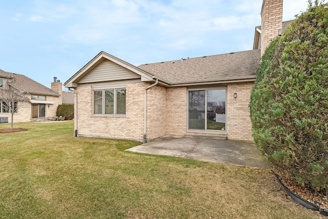 back of house with central AC unit, a patio area, and a yard