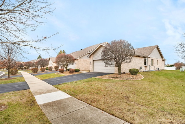 view of front of home with a garage and a front yard