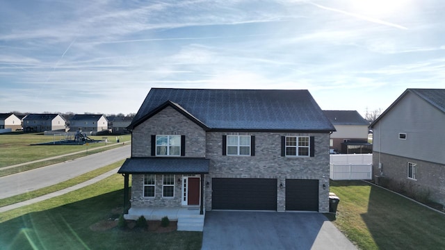 view of front of home with a front lawn and a garage