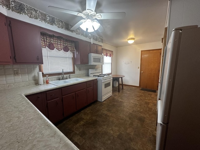 kitchen with backsplash, ceiling fan, white appliances, and sink