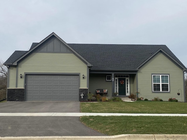 view of front of home featuring a garage and a front lawn