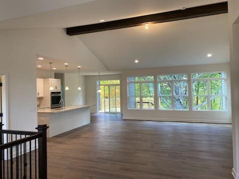 unfurnished living room with beamed ceiling, dark hardwood / wood-style flooring, and high vaulted ceiling