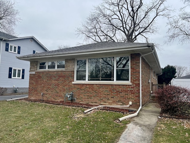 view of side of home featuring a lawn