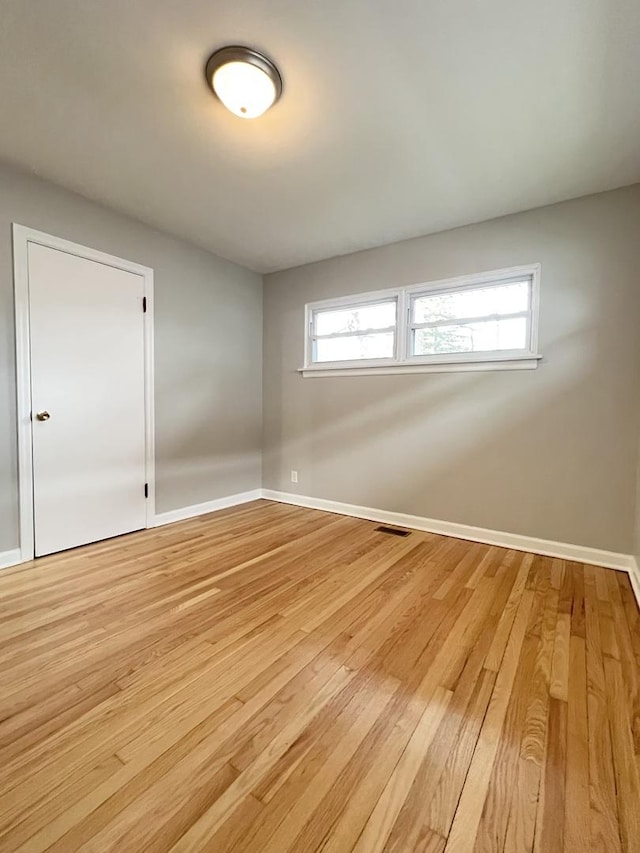 spare room with light wood-type flooring