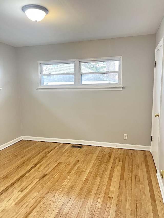 unfurnished room with light wood-type flooring