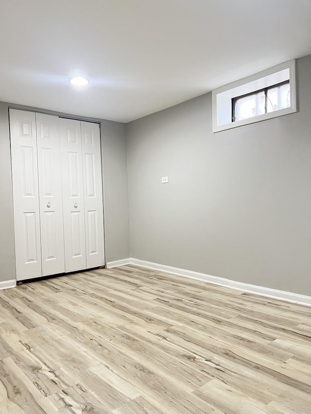 unfurnished bedroom with a closet and light hardwood / wood-style flooring