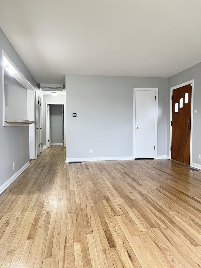 unfurnished living room with light hardwood / wood-style flooring