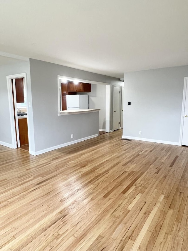 unfurnished living room featuring light hardwood / wood-style floors