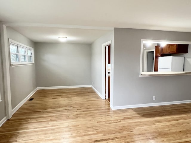 spare room featuring light hardwood / wood-style flooring