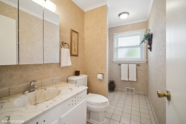 bathroom featuring toilet, tile patterned flooring, vanity, and ornamental molding