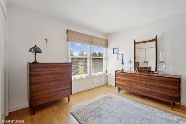 bedroom featuring light wood-type flooring and ornamental molding